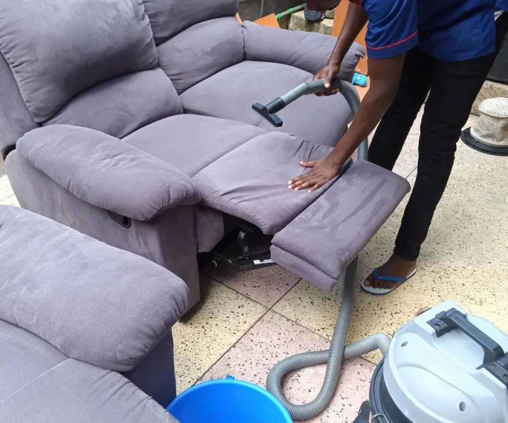 woman cleaning a sofa in nyayo estate nairobi